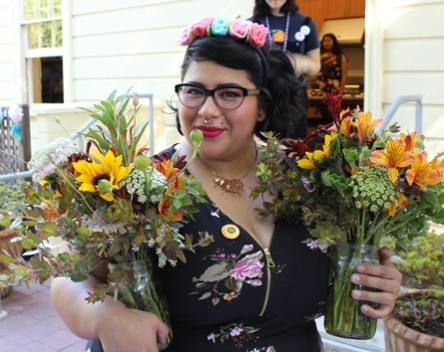 Tracy, our Program Coordinator, holding flowers from the UCSC Farm at the End of Year Celebration 2018